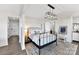 Bright bedroom featuring a black metal bed frame, modern light fixtures, and access to other rooms at 9115 Clement Cir, Terrell, NC 28682