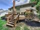 Back deck with multi-level design overlooking a lush yard and showcasing an inviting outdoor space at 9116 Torrence Creek Ct, Huntersville, NC 28078