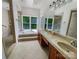 Bright and spacious bathroom features double sinks, large windows, a soaking tub, and walk-in shower at 9116 Torrence Creek Ct, Huntersville, NC 28078