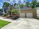 Charming brick home featuring a two-car garage, landscaped front yard, and a welcoming entrance at 9116 Torrence Creek Ct, Huntersville, NC 28078