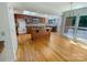 Bright kitchen with an island cooktop, stainless appliances, hardwood floors, and a wall of windows at 9116 Torrence Creek Ct, Huntersville, NC 28078