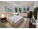 Stylishly staged main bedroom featuring a comfortable bed, soft lighting, and serene wall art at 9116 Torrence Creek Ct, Huntersville, NC 28078