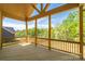 Scenic back porch with wood floors, wooden railing, and view of lush greenery at 104. Wilharr Ct # 40, Mooresville, NC 28115