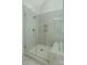 Bathroom featuring tiled walk-in shower with glass door and built in toiletry shelf at 104 Wilharr Ct # 40, Mooresville, NC 28115
