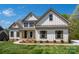 Beautiful home featuring a bright white exterior, charming brown shutters, and a well-manicured front yard at 104. Wilharr Ct # 40, Mooresville, NC 28115