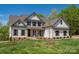Charming two-story home boasts a landscaped yard, neutral paint, and dark shutters at 104. Wilharr Ct # 40, Mooresville, NC 28115