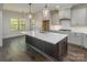 Spacious kitchen featuring a large island with a white countertop, wood floors, and stylish pendant lighting at 104. Wilharr Ct # 40, Mooresville, NC 28115