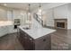 Bright kitchen with large island, stainless appliances, and adjacent living room at 104. Wilharr Ct # 40, Mooresville, NC 28115