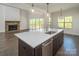 Bright kitchen with island, stainless appliances, and views of the backyard deck at 104. Wilharr Ct # 40, Mooresville, NC 28115