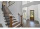 Elegant staircase with dark wood treads, wrought iron railings, and natural light at 104 Wilharr Ct # 40, Mooresville, NC 28115