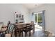 Bright dining area with a table, chairs and sliding doors leading to the backyard, perfect for Gathering meals at 1109 Culver Spring Way, Charlotte, NC 28215