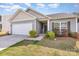 A well-kept one-story home featuring an attached garage and landscaped front yard, offering comfort and convenience at 1109 Culver Spring Way, Charlotte, NC 28215