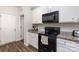 Functional kitchen with white cabinets, a black microwave, and plenty of counter space, ideal for cooking enthusiasts at 1109 Culver Spring Way, Charlotte, NC 28215