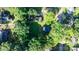 Aerial view of property boundaries with a one-story home nestled among mature trees in a residential neighborhood at 116 Barnes Ln, Stony Point, NC 28678