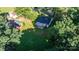 Aerial view of a cozy home with a metal roof, set among lush greenery at 116 Barnes Ln, Stony Point, NC 28678