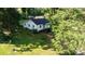Aerial view of a house with a spacious lawn, surrounded by trees in a peaceful setting at 116 Barnes Ln, Stony Point, NC 28678