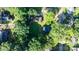 Aerial view of a home nestled among mature trees in a residential neighborhood at 116 Barnes Ln, Stony Point, NC 28678