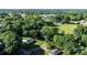 Aerial view showing a house surrounded by mature trees and a spacious lawn at 116 Barnes Ln, Stony Point, NC 28678