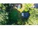 An aerial view of a home with an outdoor patio and a large backyard with mature trees in a residential neighborhood at 116 Barnes Ln, Stony Point, NC 28678