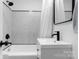 Modern bathroom with tiled walls, sleek vanity, black hardware, and shower-tub combo at 116 Barnes Ln, Stony Point, NC 28678