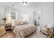 Comfortable bedroom featuring natural light, wood-look flooring, and charming decor at 116 Barnes Ln, Stony Point, NC 28678