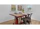 Dining room featuring wood floors, ample natural light, and a unique adjustable table at 116 Barnes Ln, Stony Point, NC 28678