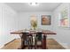 Bright dining room with wood-look floors, seating for four, and natural light at 116 Barnes Ln, Stony Point, NC 28678