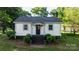 Charming single-story home with black stairway, manicured bushes, and mature trees at 116 Barnes Ln, Stony Point, NC 28678