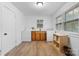 Well-lit laundry room featuring wood-look floors, sink with wooden cabinets, washer, and dryer at 116 Barnes Ln, Stony Point, NC 28678