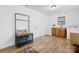 Bright laundry room with wood-look floors, washer, dryer, wooden cabinets, and storage rack at 116 Barnes Ln, Stony Point, NC 28678