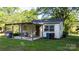 Cozy home featuring a covered patio perfect for outdoor dining with mature trees and a grill at 116 Barnes Ln, Stony Point, NC 28678