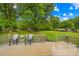 Enjoy the outdoors on the wood deck with table and chairs overlooking the spacious lush green backyard at 117 Ethel Ln, Statesville, NC 28625