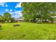 Expansive backyard offers mature trees, a playground and fire pit, making it perfect for entertaining at 117 Ethel Ln, Statesville, NC 28625