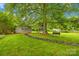 Sprawling backyard boasts mature trees, storage shed, and playground, perfect for outdoor enjoyment at 117 Ethel Ln, Statesville, NC 28625