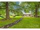 Large backyard with mature trees, garden and path leading to the house, ideal for relaxing at 117 Ethel Ln, Statesville, NC 28625