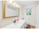Bathroom features a white vanity with updated fixtures, a large mirror, and wood floors at 117 Ethel Ln, Statesville, NC 28625