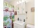 Small bathroom offers a single sink, wall-mounted mirror, and shower with playful monkey-themed curtain at 117 Ethel Ln, Statesville, NC 28625