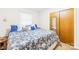 Cozy bedroom features a large bed with floral bedding, a side table, and a mirrored closet door at 117 Ethel Ln, Statesville, NC 28625