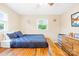 Bedroom with wooden floors, built-in platform bed, natural light, and a small chest of drawers at 117 Ethel Ln, Statesville, NC 28625