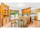 Bright kitchen area featuring wood cabinetry, adjacent dining table with backyard view through sliding glass door at 117 Ethel Ln, Statesville, NC 28625