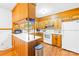 Kitchen boasts wood cabinets, white countertop and appliances, plus a modern stainless steel trash can at 117 Ethel Ln, Statesville, NC 28625