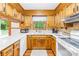 This kitchen features lots of counter space, wood cabinets, and views of a backyard space from two windows at 117 Ethel Ln, Statesville, NC 28625