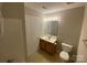 Standard bathroom featuring a single sink vanity, toilet, and tile floors at 118 Steam Engine Dr # 201, Mooresville, NC 28115