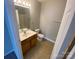 Bathroom with a wood vanity, toilet, mirror, and shower-tub combo at 118 Steam Engine Dr # 201, Mooresville, NC 28115