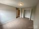 Standard bedroom with a neutral carpet, and a closet with sliding doors at 118 Steam Engine Dr # 201, Mooresville, NC 28115