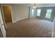 Spacious bedroom with large windows and neutral carpet, offering ample natural light at 118 Steam Engine Dr # 201, Mooresville, NC 28115