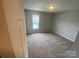 Neutral bedroom with carpet, one window, and base trim at 118 Steam Engine Dr # 201, Mooresville, NC 28115