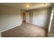 Bedroom with neutral carpet, double closet, and a base trim at 118 Steam Engine Dr # 201, Mooresville, NC 28115