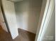 Bedroom closet with carpeted floor and one shelf with a hanging rod at 118 Steam Engine Dr # 201, Mooresville, NC 28115