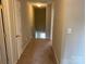 Hallway with neutral paint and carpeting leading to stairs and adjacent rooms with closed white doors at 118 Steam Engine Dr # 201, Mooresville, NC 28115
